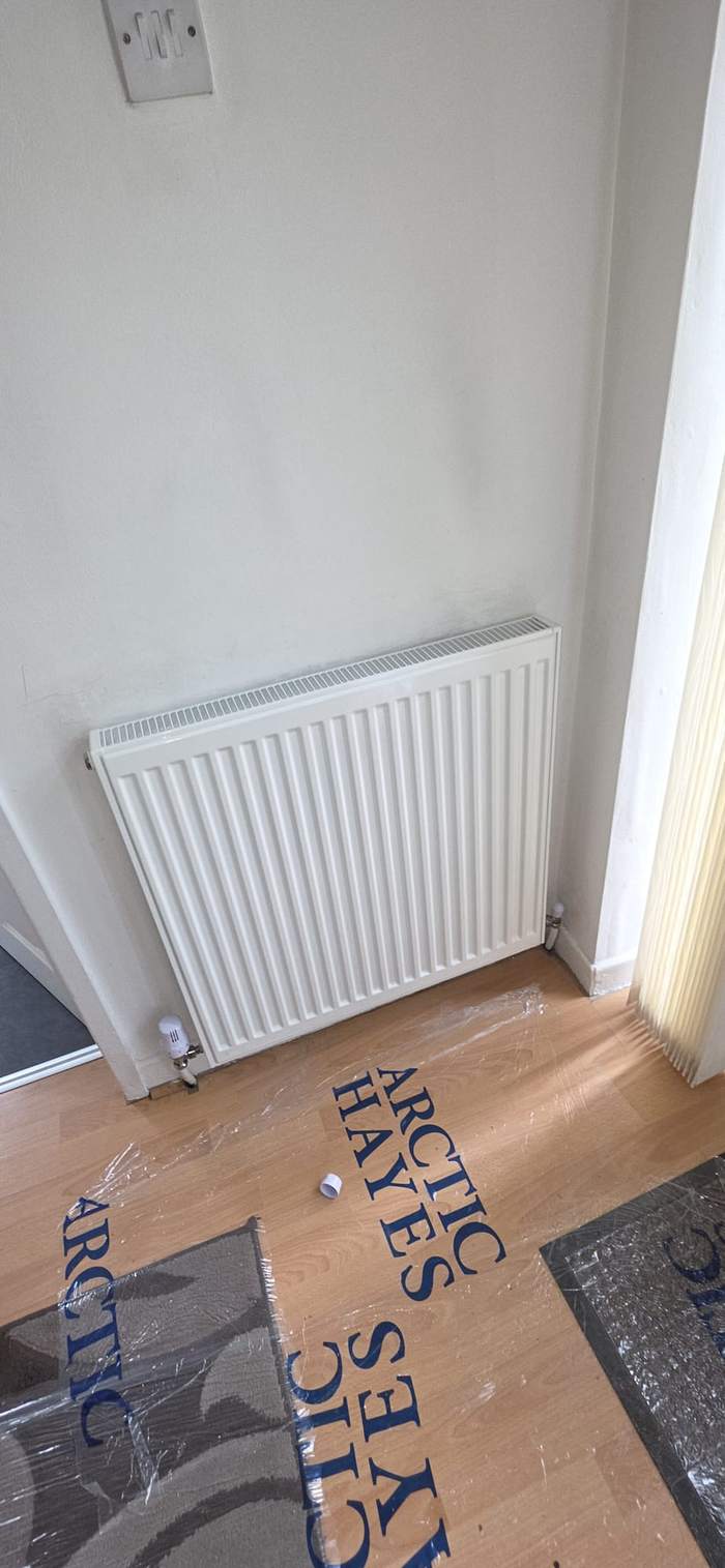 Radiator fitted in a corner over laminate flooring