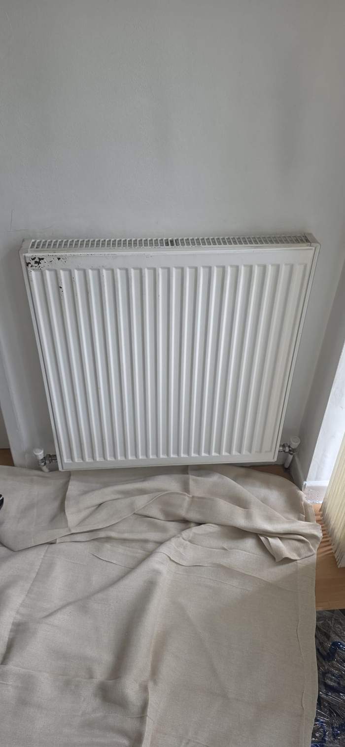 Radiator refitted with dust sheets protecting the floor